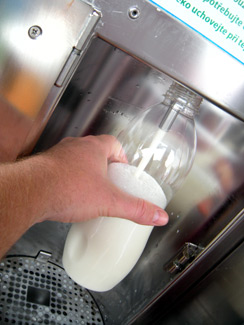 Filling the bottle at automated milk dispenser